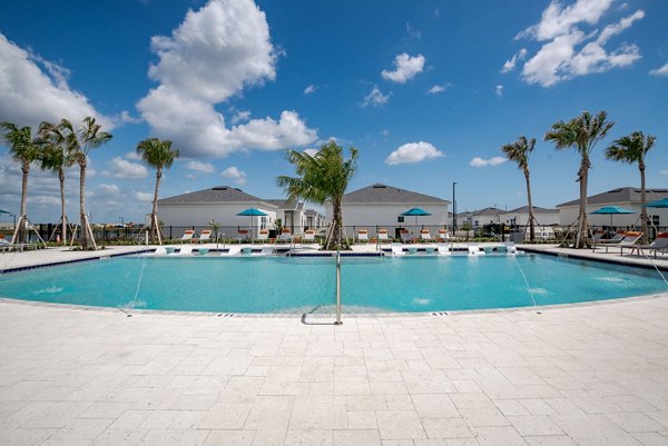 Resort-style pool with lounge chairs at Bay Court within Eden Heritage Lakes Apartments