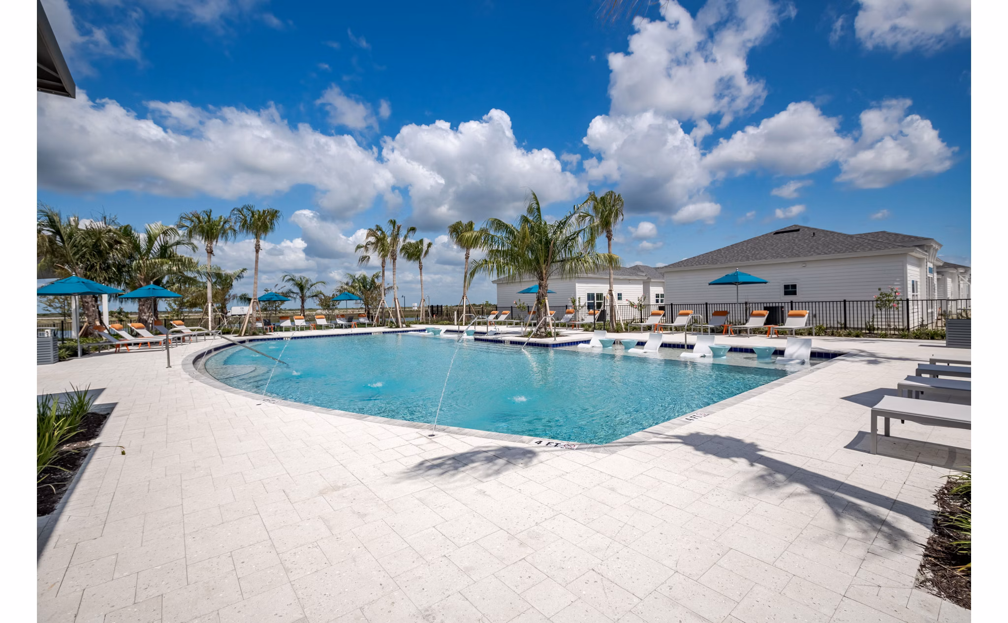 Resort-style pool surrounded by lush landscaping at Bay Court in Eden Heritage Lakes Apartments