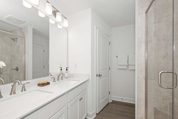 Luxurious bathroom featuring modern fixtures and marble countertops in Affinity at Hudson Apartments
