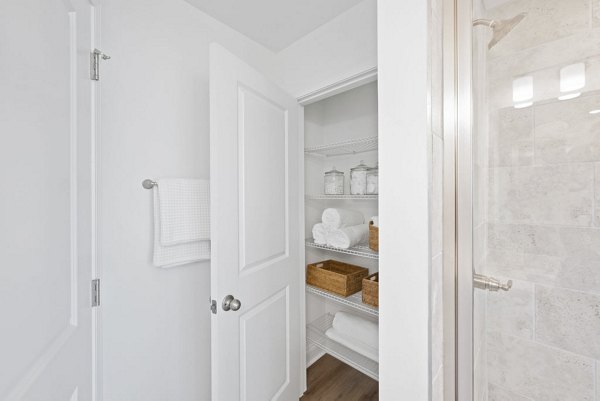 Modern bathroom with granite countertops and stainless fixtures in Affinity at Hudson Apartments