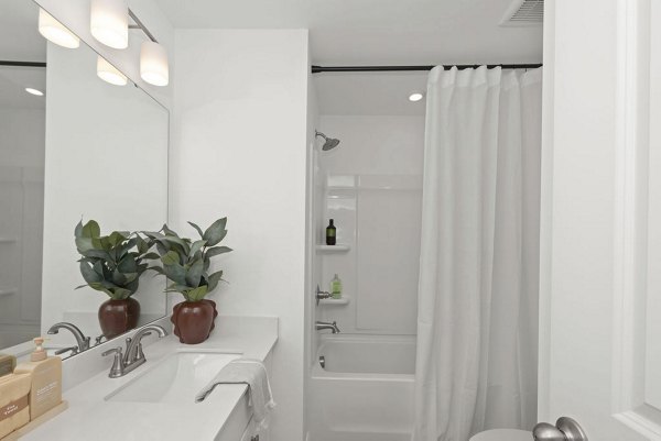 Bathroom with modern fixtures and granite countertops in Affinity at Hudson Apartments