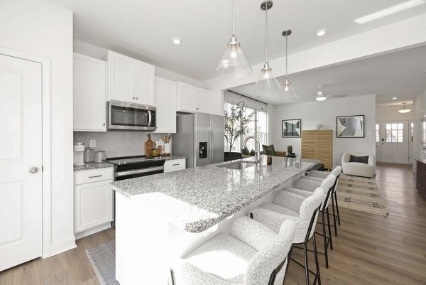 Modern kitchen featuring stainless steel appliances in Affinity at Hudson Apartments, by Greystar