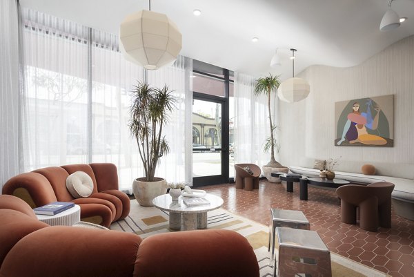 Luxurious clubhouse with modern decor at The Charlie WeHo Apartments, perfect for social gatherings and community events