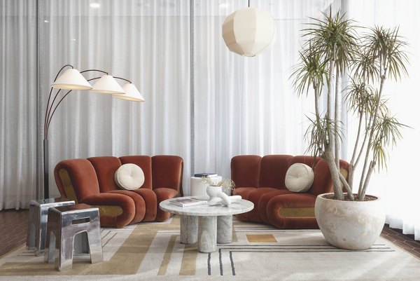Clubhouse lounge with modern decor and seating at The Charlie WeHo Apartments, a Greystar luxury property located in West Hollywood