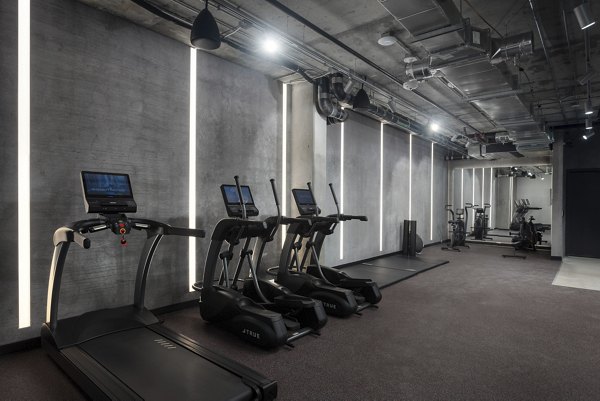 Modern fitness center with cutting-edge equipment at The Charlie WeHo Apartments