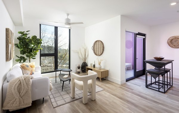 Spacious living room with modern furnishings in The Charlie WeHo Apartments