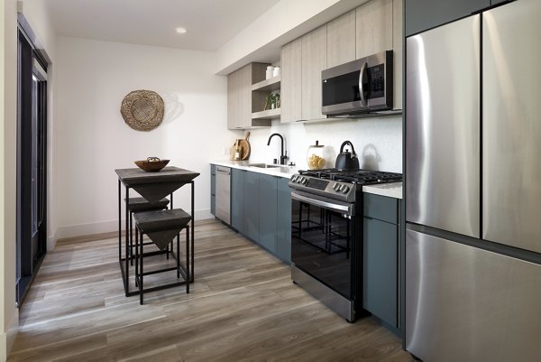 Contemporary kitchen with marble countertops at The Charlie WeHo Apartments