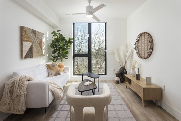 Spacious living room with modern furnishings at The Charlie WeHo Apartments, West Hollywood Luxury Apartments