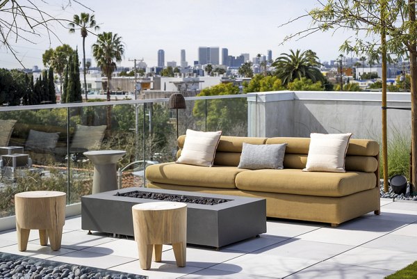 The Charlie WeHo Apartments: Serene courtyard featuring lush landscaping and modern seating in West Hollywood