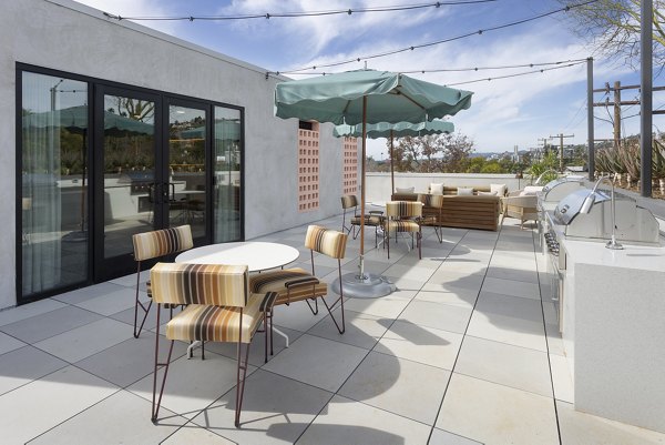 Grill area with barbecue stations at The Charlie WeHo Apartments