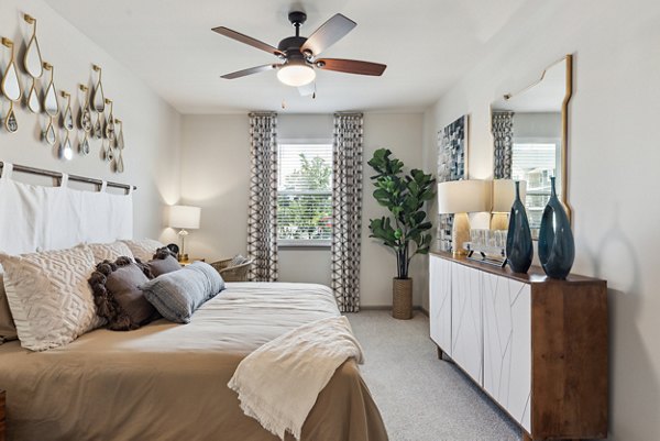 Modern bedroom with plush bed and stylish decor at Riverchase Vista Apartments