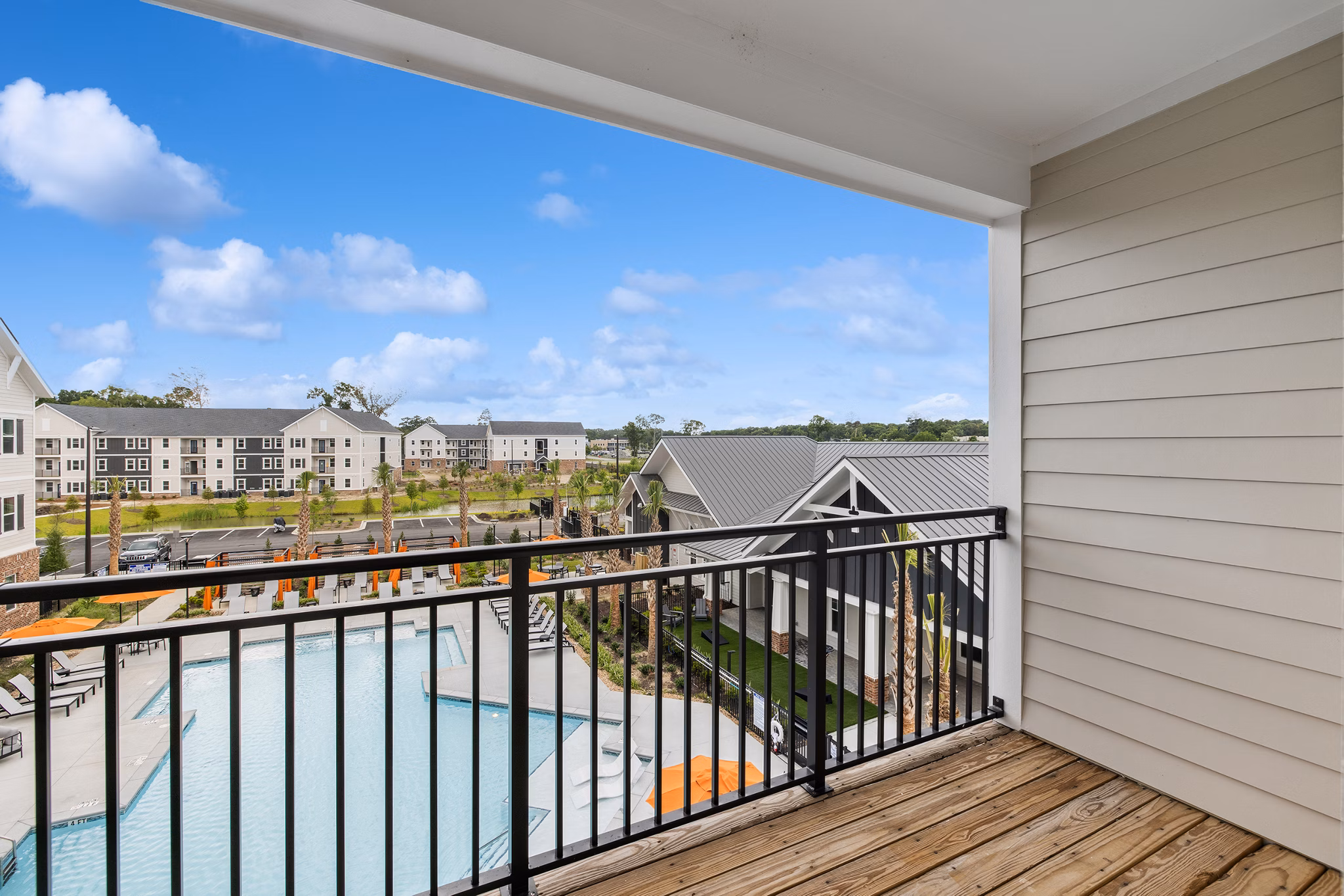 Modern patio with outdoor seating at Riverchase Vista Apartments overlooking lush green landscape