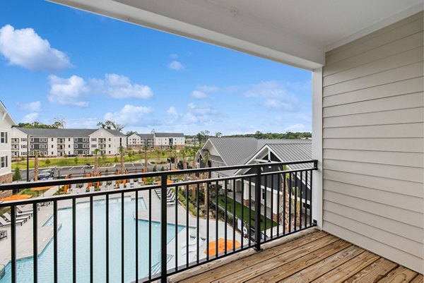 Modern patio with outdoor seating at Riverchase Vista Apartments overlooking lush green landscape