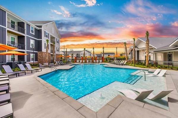 Relaxing pool at Riverchase Vista Apartments with lounge chairs and landscaped surroundings