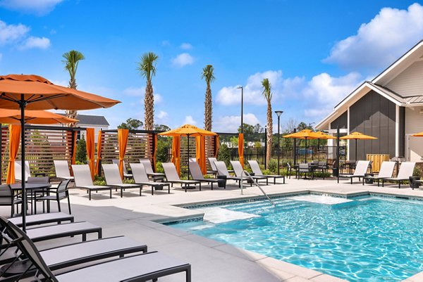 Outdoor pool with lounge chairs and lush landscaping at Riverchase Vista Apartments offering luxury living experiences