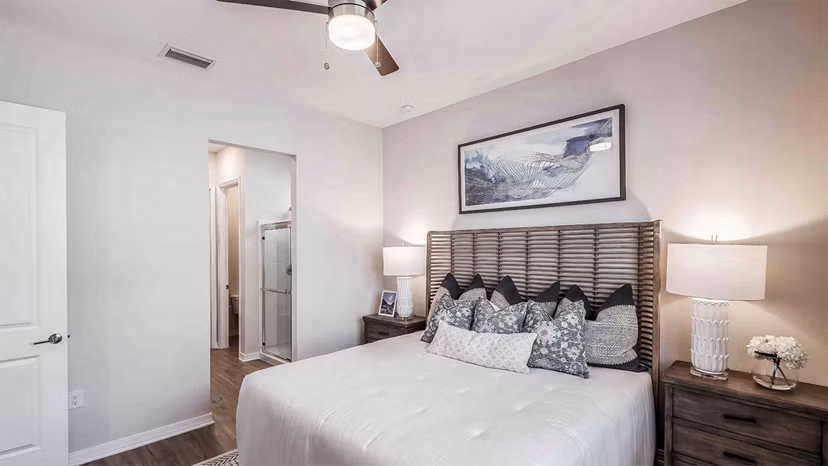 Bedroom featuring elegant dÃ©cor and plush bedding at Yardly Artisan Lakes Homes