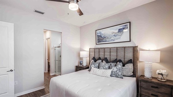 Bedroom featuring elegant dÃ©cor and plush bedding at Yardly Artisan Lakes Homes