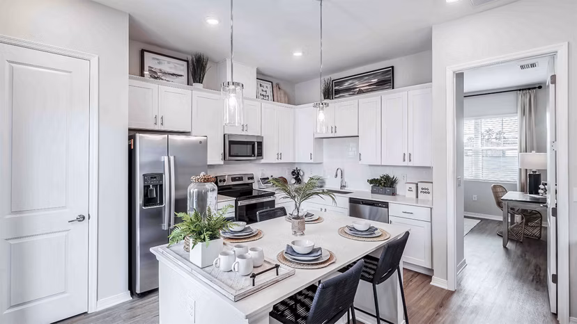 Modern kitchen with stainless steel appliances at Yardly Artisan Lakes Homes
