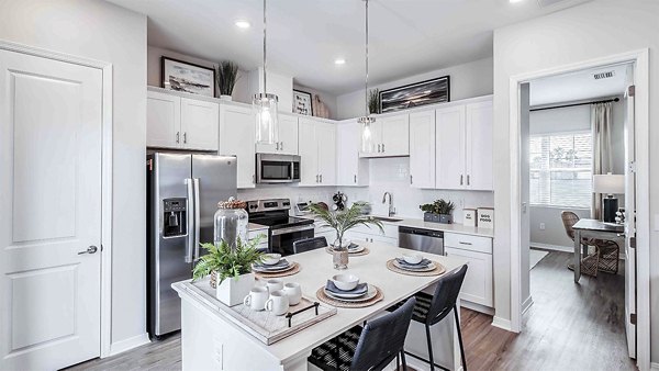 Modern kitchen with stainless steel appliances at Yardly Artisan Lakes Homes