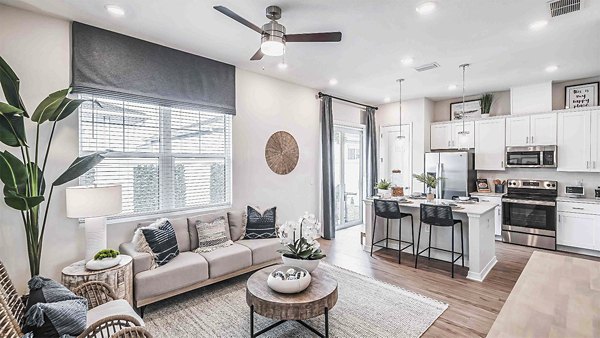 Living room with stylish decor and natural light at Yardly Artisan Lakes Homes