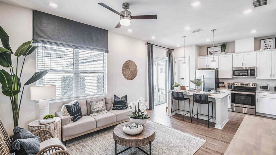 Living room with stylish decor and natural light at Yardly Artisan Lakes Homes