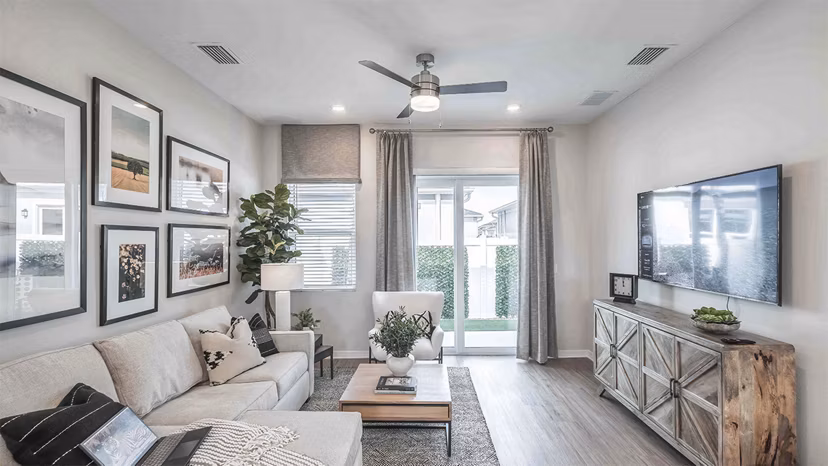 Spacious living room with modern furniture and large windows in Yardly Artisan Lakes Homes