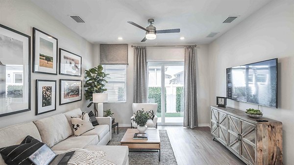 Spacious living room with modern furniture and large windows in Yardly Artisan Lakes Homes