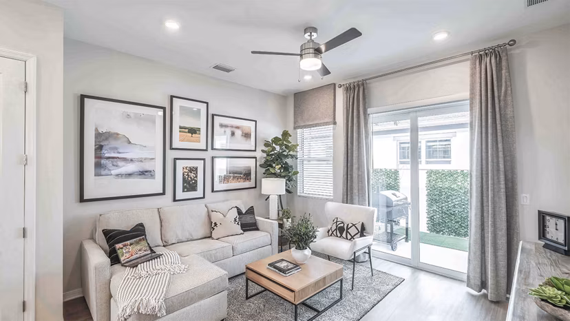 Living room with stylish decor and natural light at Yardly Artisan Lakes Homes