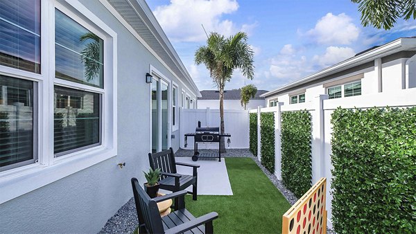 Patio with modern outdoor seating at Yardly Artisan Lakes Homes