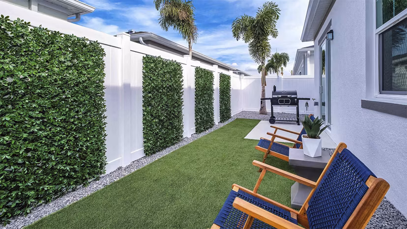 Yardly Artisan Lakes Homes: Cozy patio with stylish outdoor seating and lush greenery, perfect for relaxation