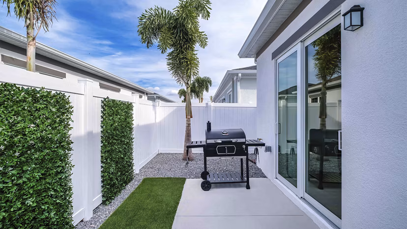 Outdoor patio with modern furniture at Yardly Artisan Lakes Homes offering scenic views and relaxation spaces