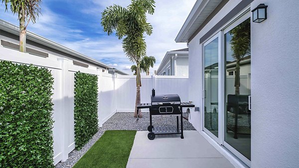 Outdoor patio with modern furniture at Yardly Artisan Lakes Homes offering scenic views and relaxation spaces