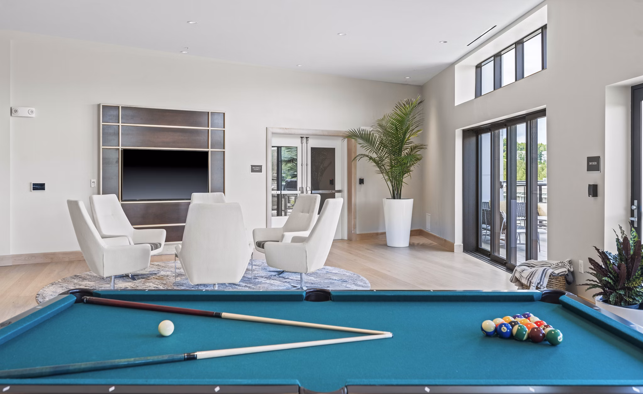Game room with pool table and arcade games at The Marek South Apartments