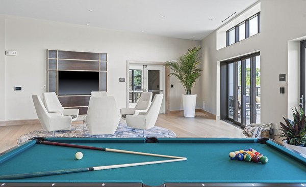 Game room with pool table and arcade games at The Marek South Apartments