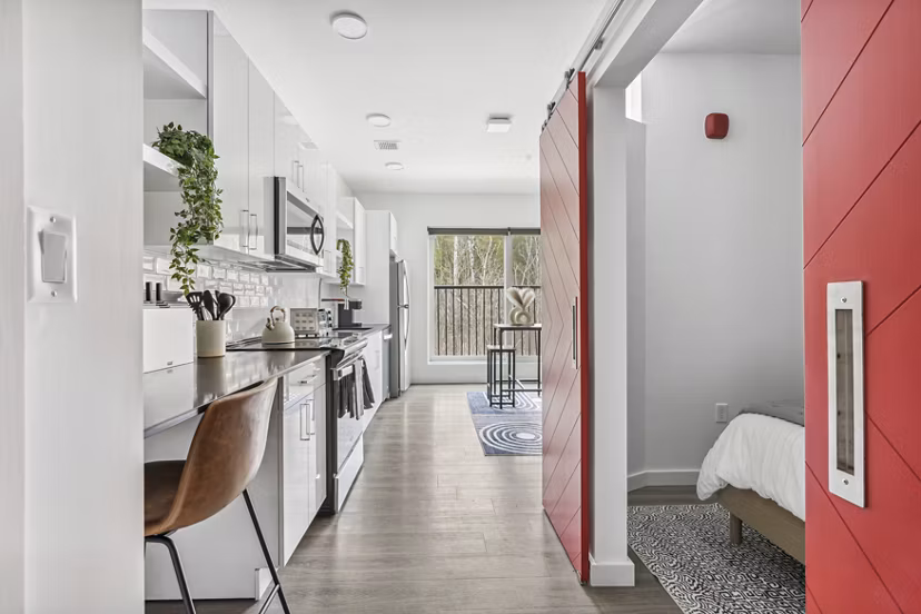 Elegant kitchen with marble countertops and stainless steel appliances at The Marek South Apartments