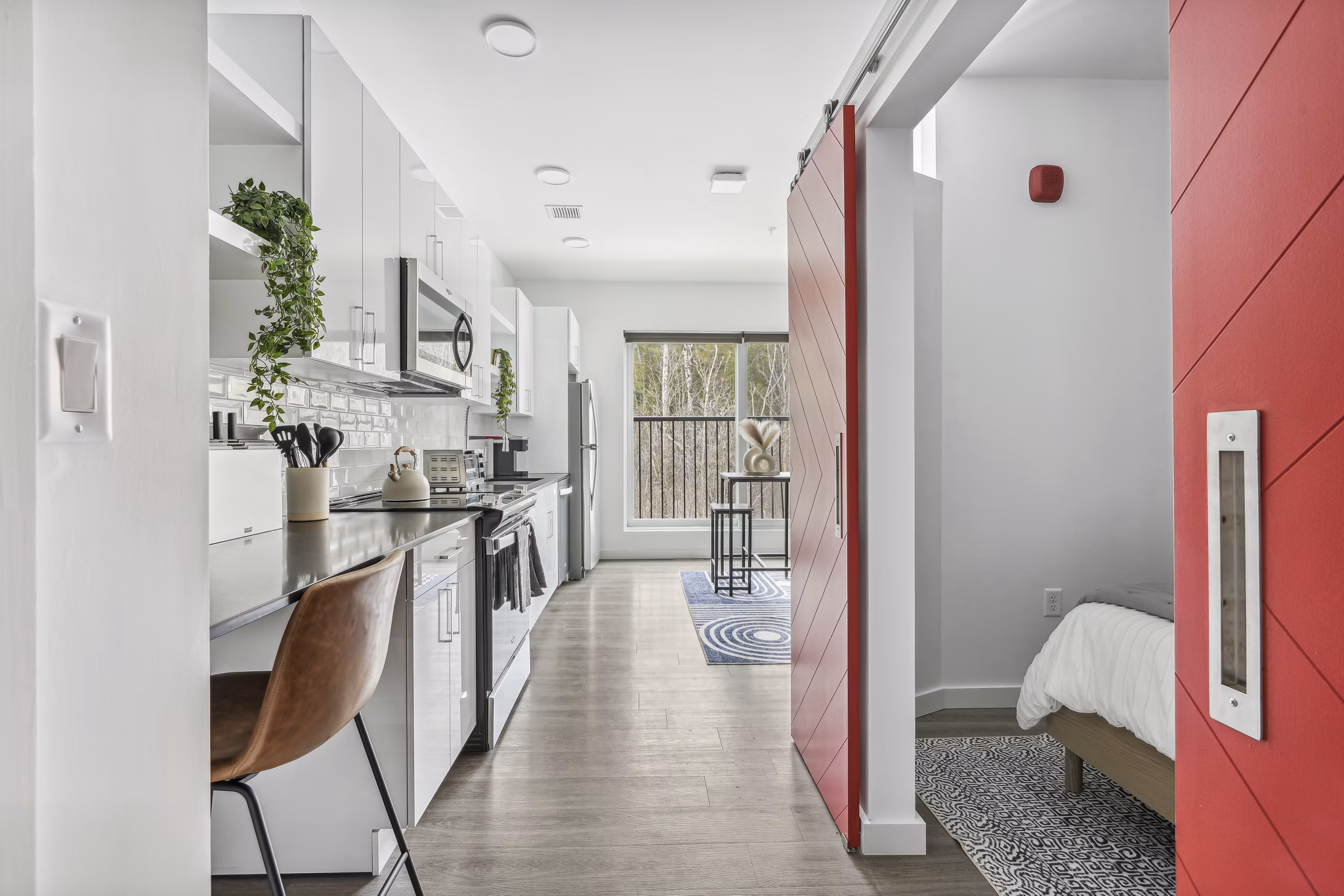 Elegant kitchen with marble countertops and stainless steel appliances at The Marek South Apartments