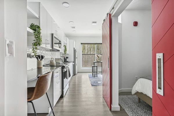 Elegant kitchen with marble countertops and stainless steel appliances at The Marek South Apartments