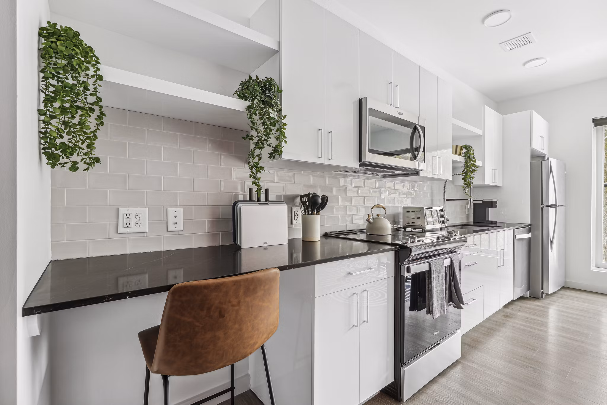 Contemporary kitchen with stainless steel appliances in The Marek South Apartments