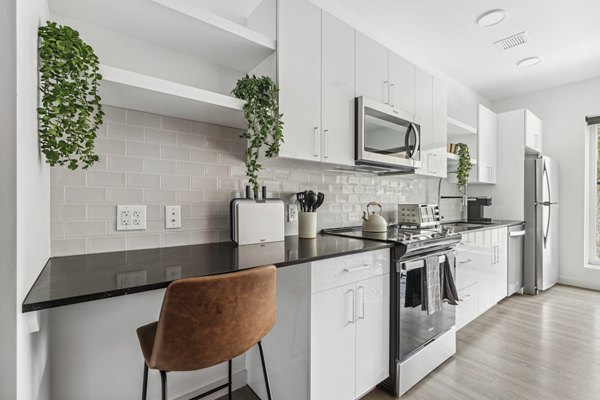 Contemporary kitchen with stainless steel appliances in The Marek South Apartments