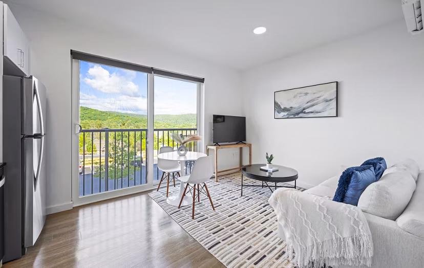Luxurious living room with modern decor at The Marek South Apartments, featuring ample natural light and spacious seating area