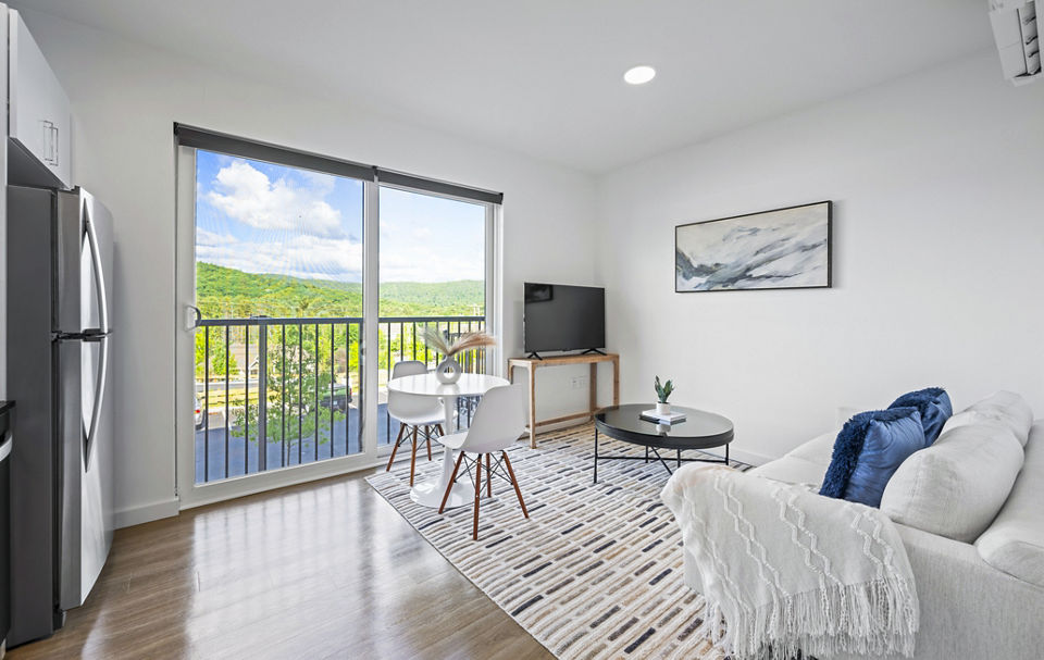 Luxurious living room with modern decor at The Marek South Apartments, featuring ample natural light and spacious seating area
