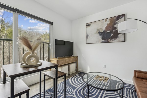 Living room at The Marek South Apartments featuring modern furniture and elegant design, offering luxury living in a prime location