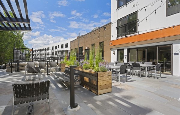 The Marek South Apartments: Cozy fire pit on a modern patio, perfect for relaxation and social gatherings