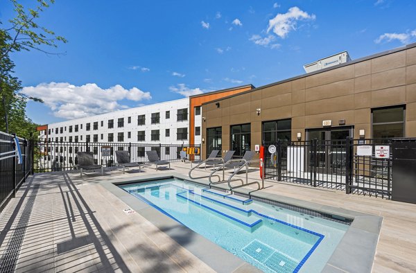 Infinity-edge pool with poolside lounging at The Marek South Apartments