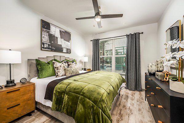 Spacious bedroom with elegant decor at The Aston at Town Center Apartments