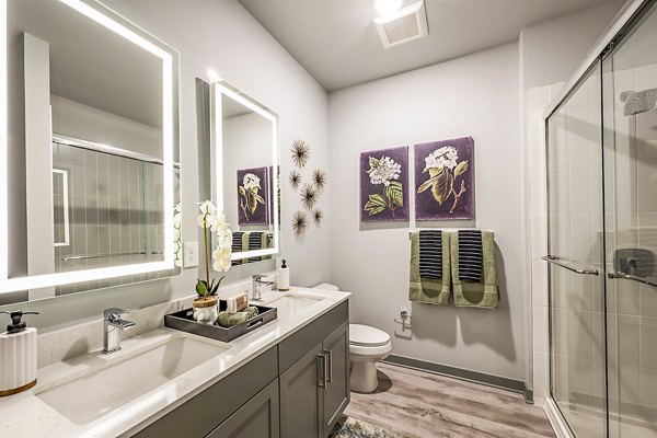 Modern bathroom with sleek fixtures at The Aston at Town Center Apartments, featuring luxury finishes and spacious layout