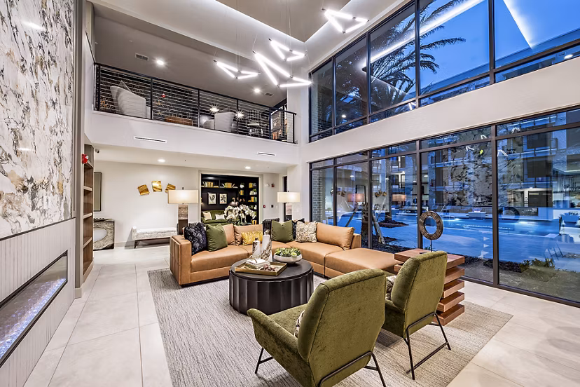The Aston at Town Center: Modern clubhouse with lounge seating and fireplace in luxury apartments community