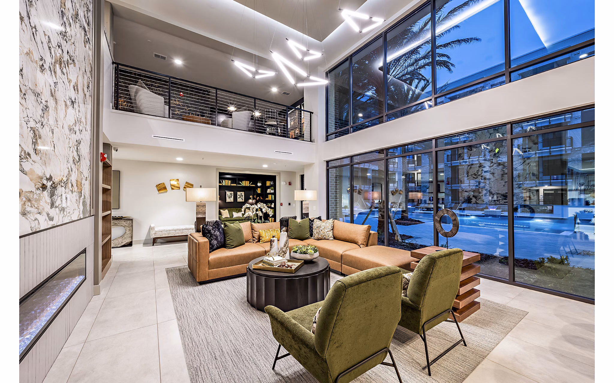 The Aston at Town Center: Modern clubhouse with lounge seating and fireplace in luxury apartments community