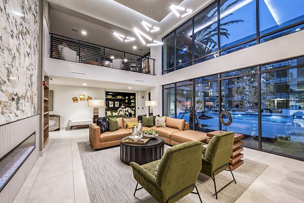 The Aston at Town Center: Modern clubhouse with lounge seating and fireplace in luxury apartments community
