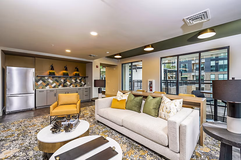 Clubhouse with modern design and comfortable seating at The Aston at Town Center Apartments, featuring elegant interiors for social gatherings